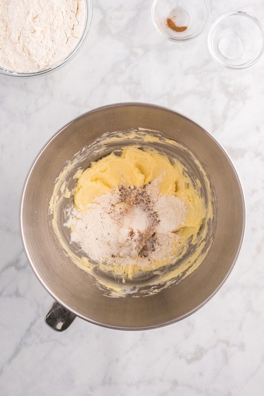 dry ingredeints being added to mixing bowl of wet ingredients