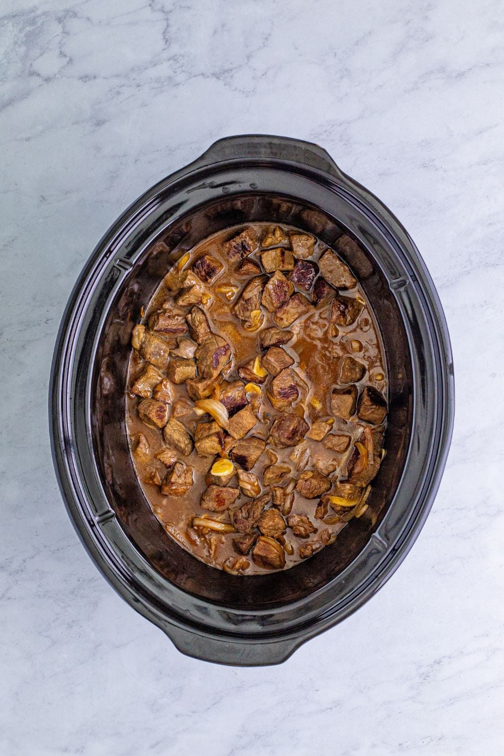 cooked steak bites in a slow cooker