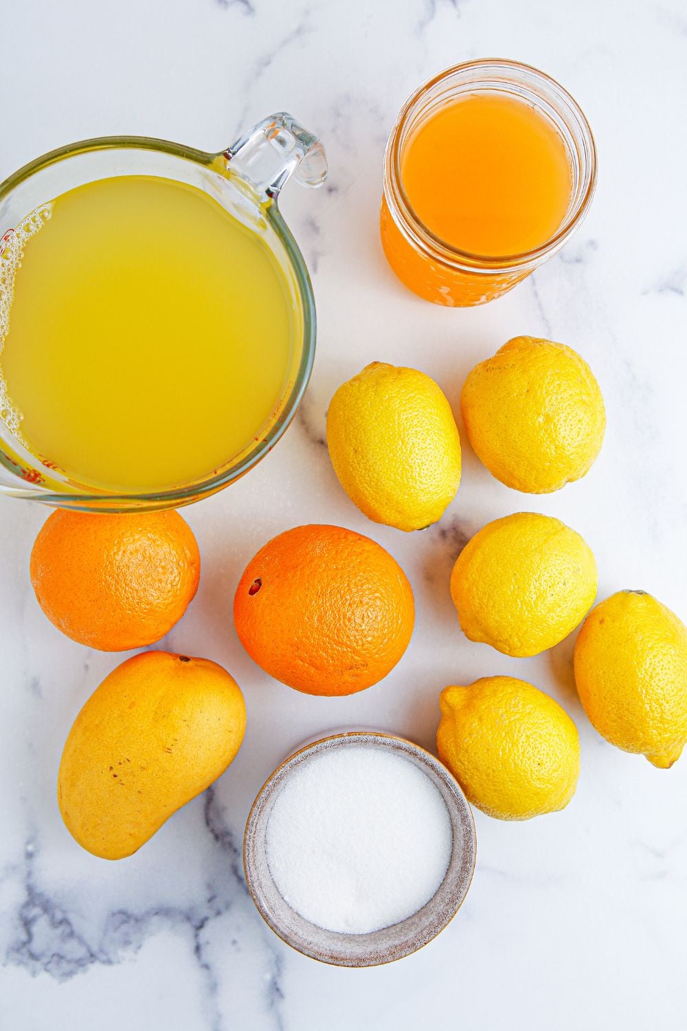 ingredients for making a tropical punch on table