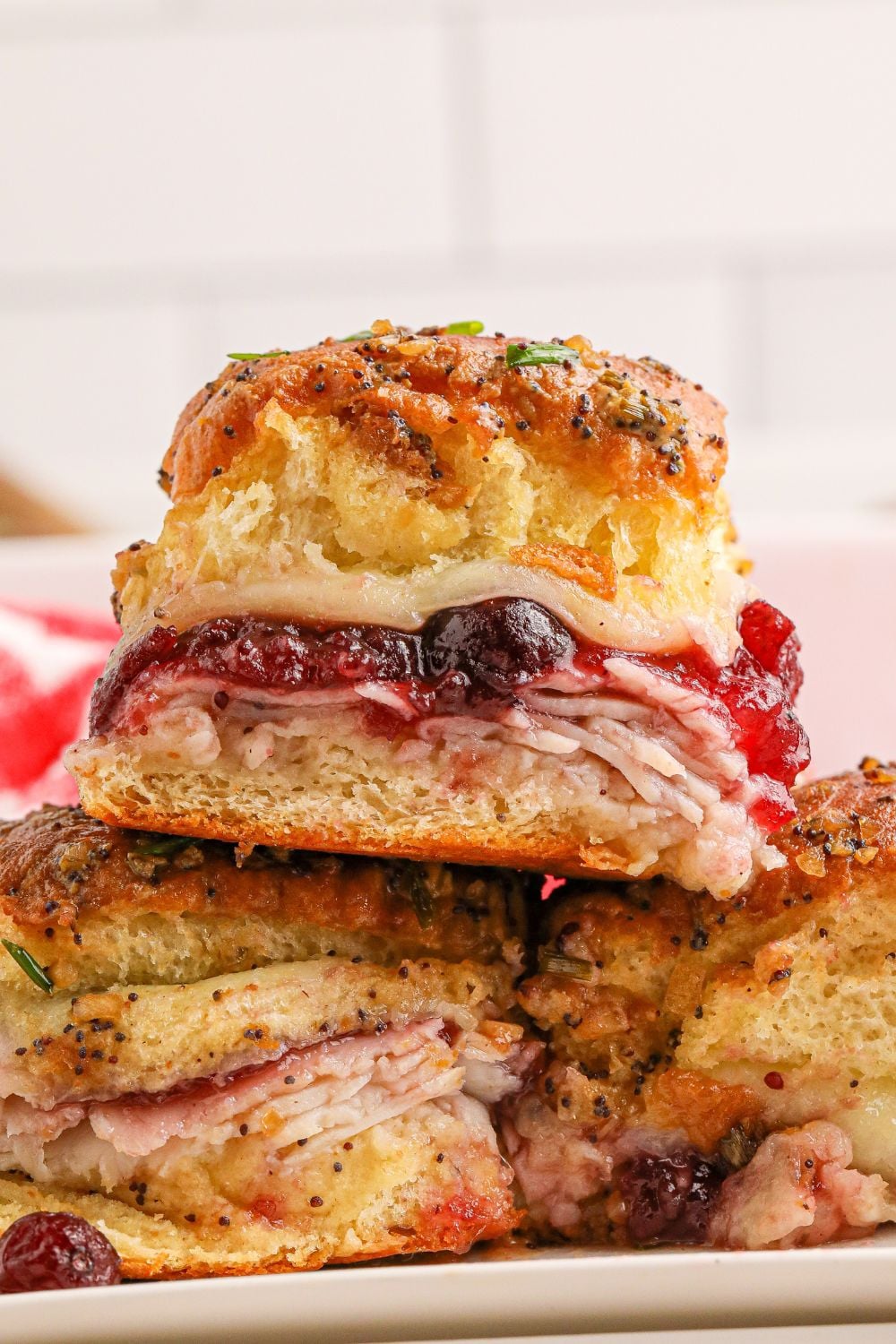 turkey sandwich with cranberries stacked on top of each other