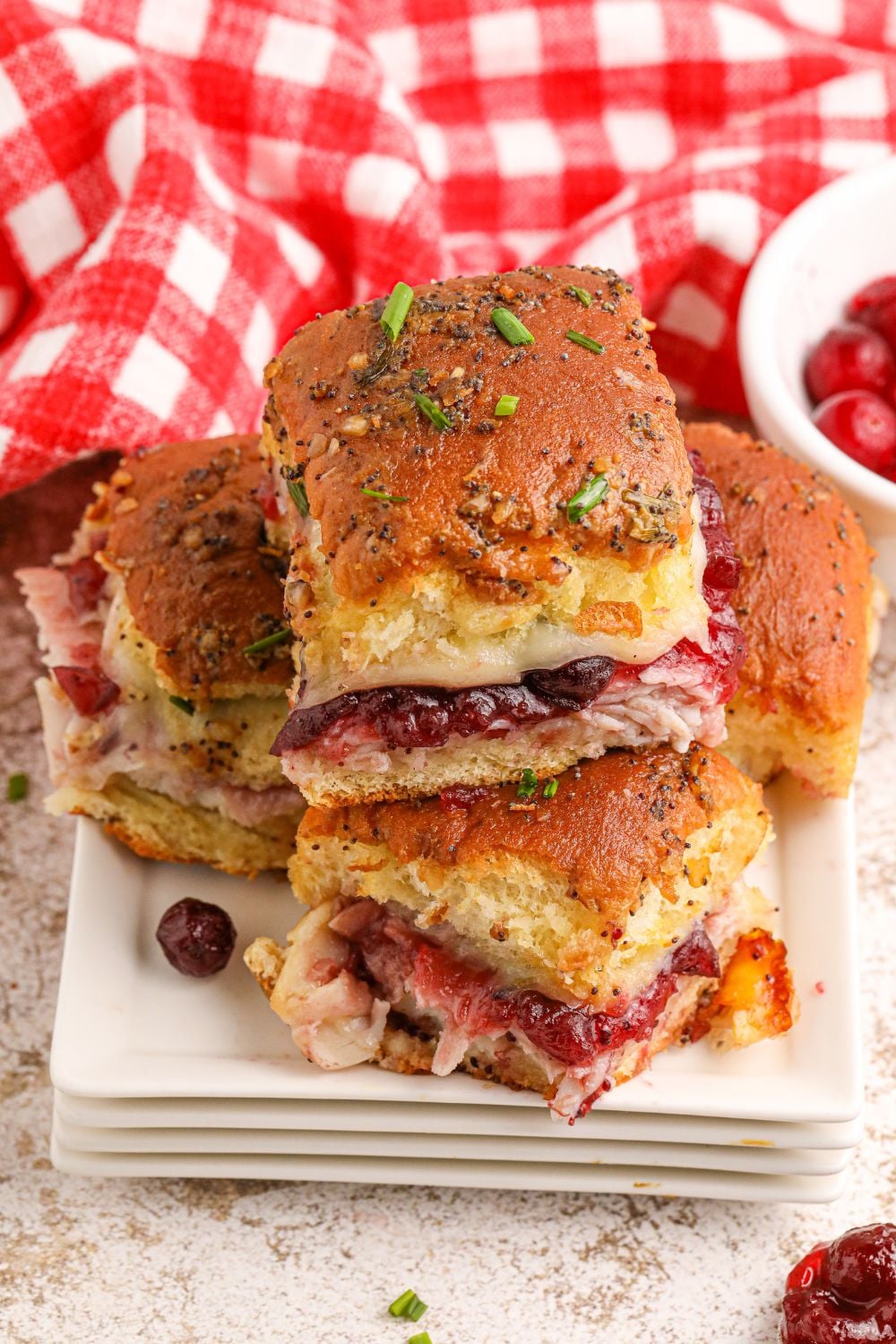 turkey sliders on a plate with a napkin behind it on table