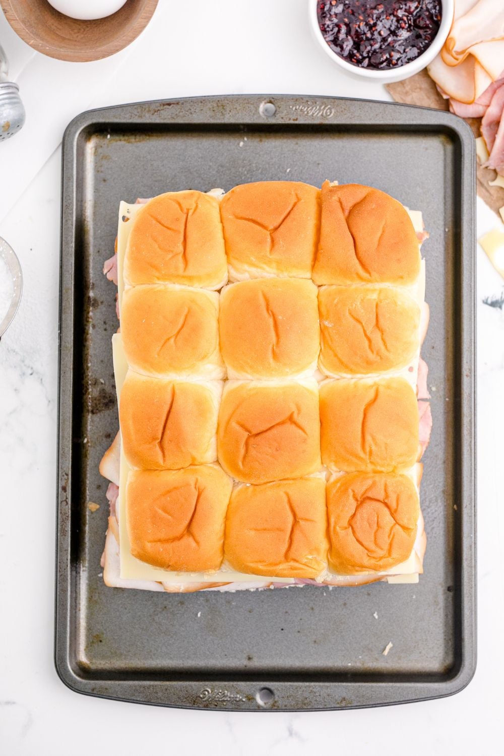 sandwiches assembled on baking tray