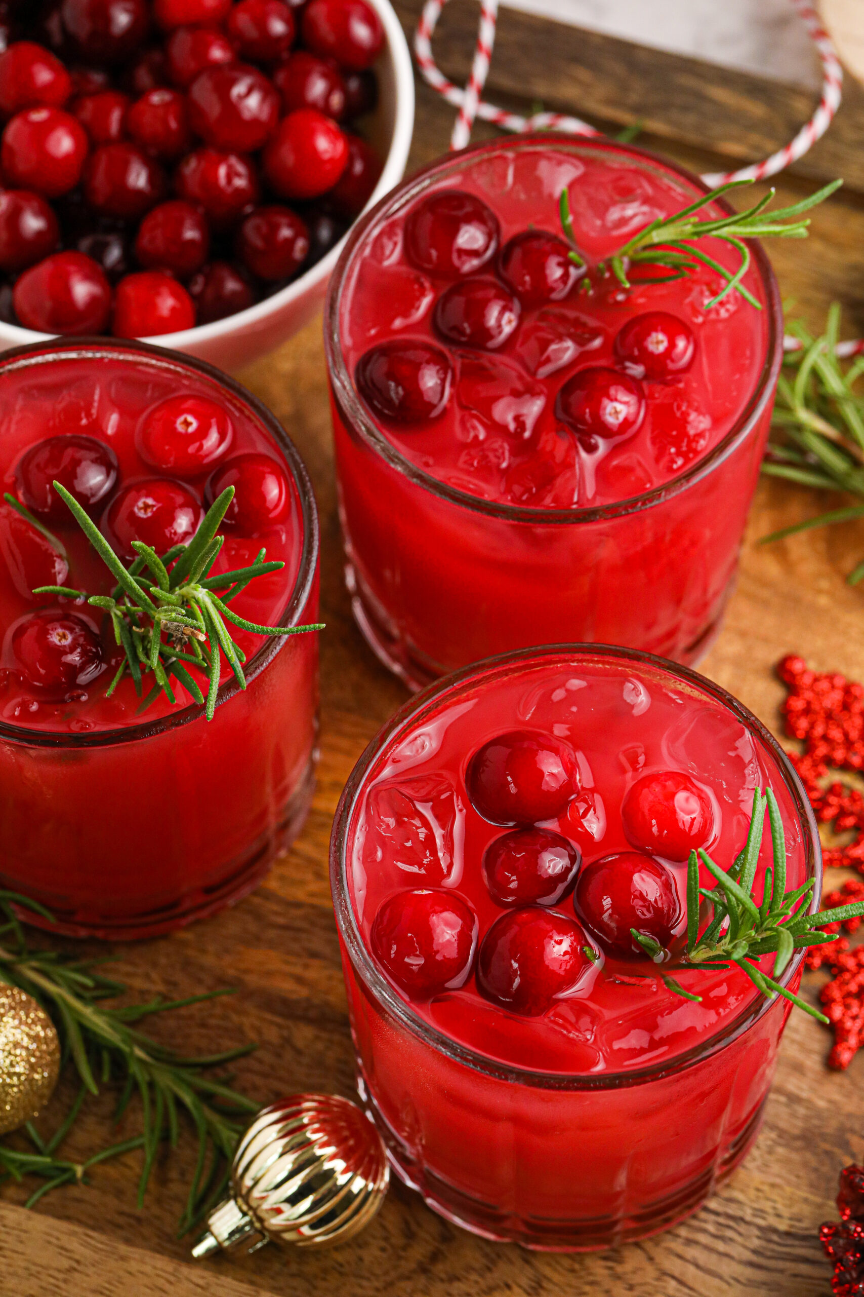 three glasses of cranberry punch on a wooden board