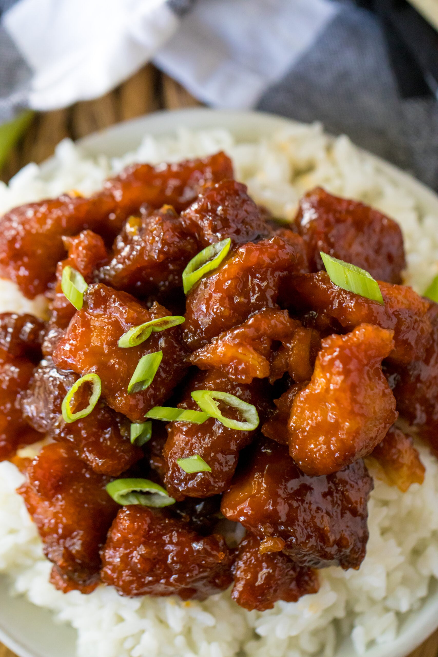 Overhead view of Slow Cooker Firecracker Chicken over white rice in a white bowl.