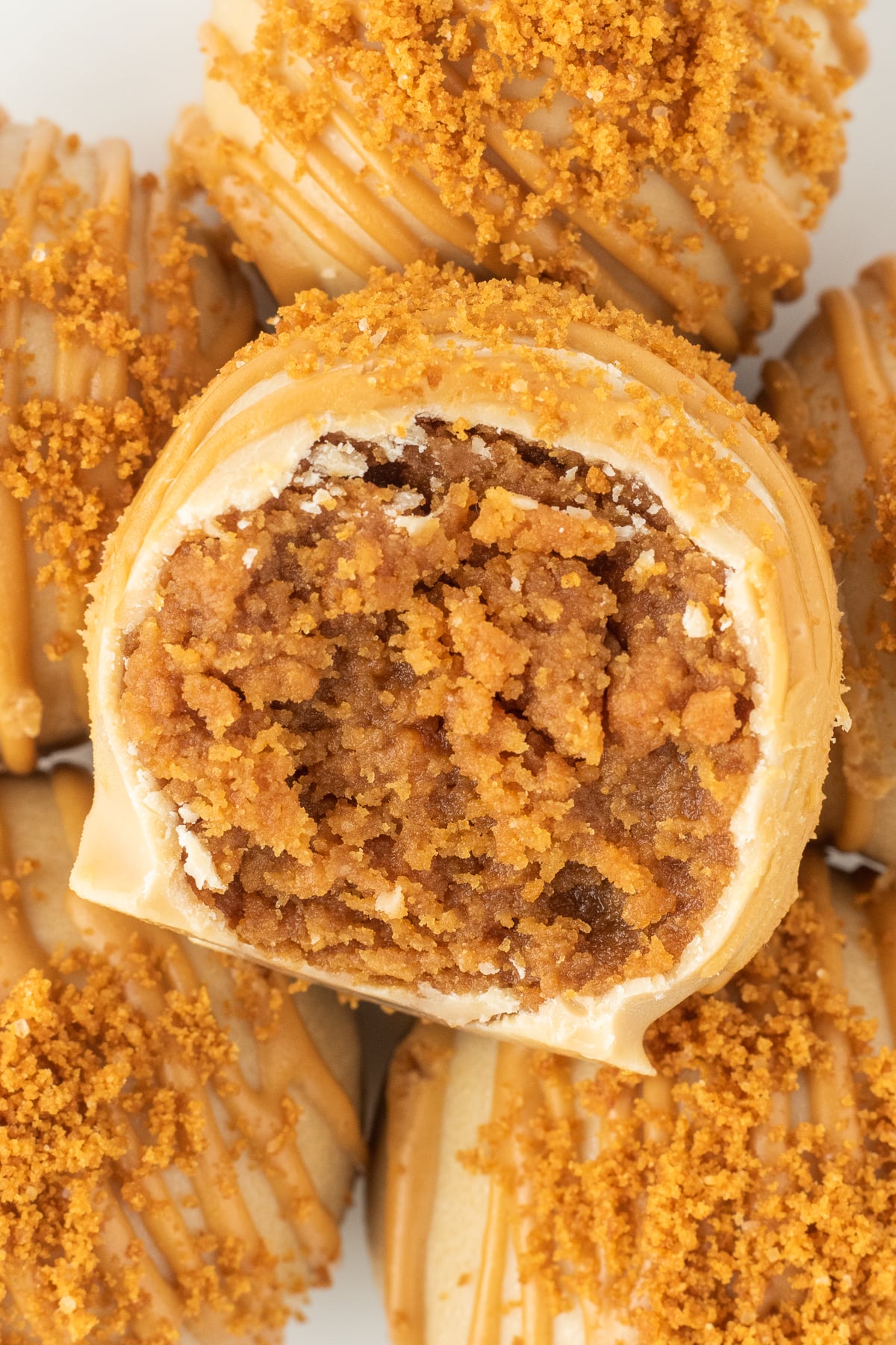 Biscoff truffles with a bite missing from the middle one