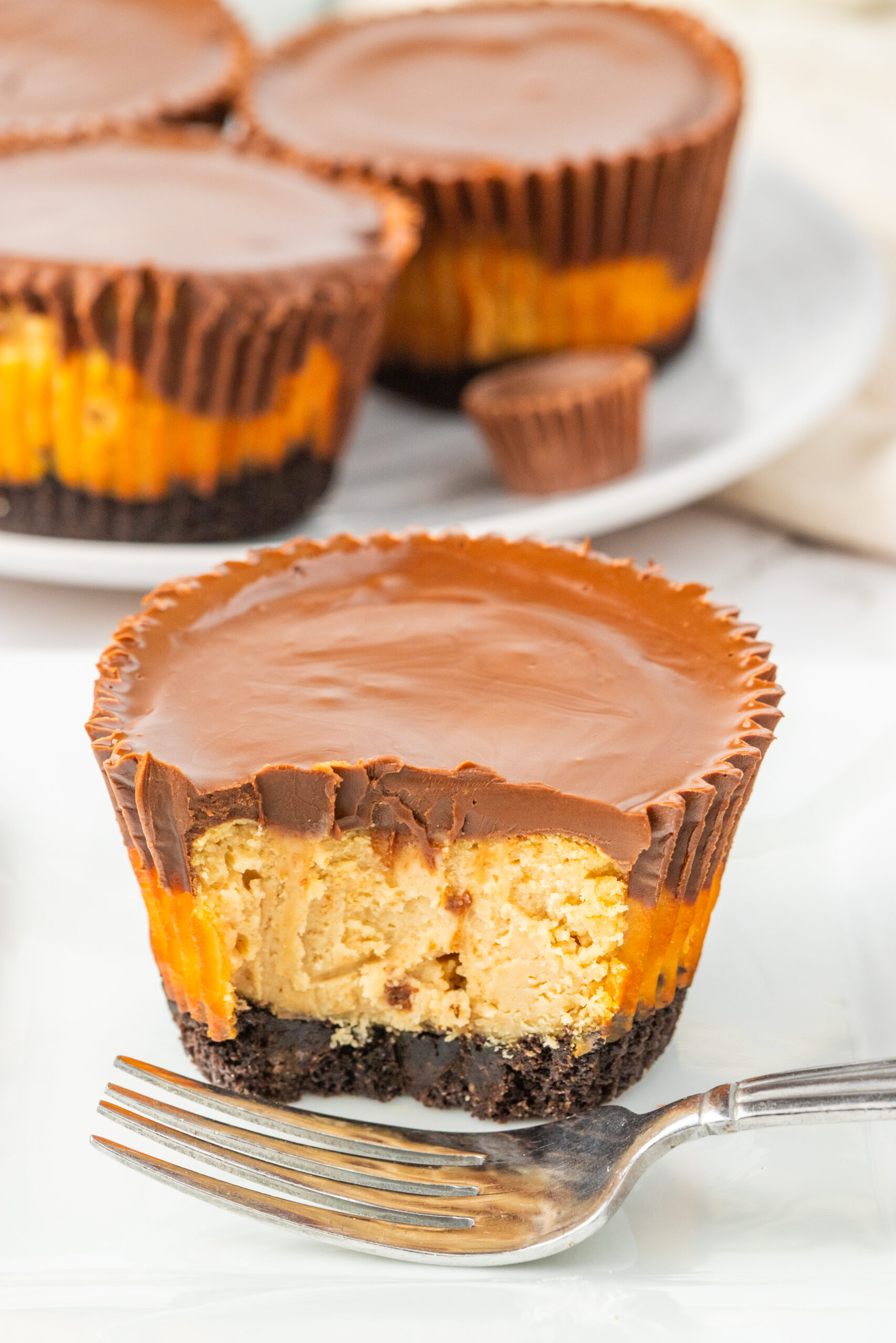 Peanut Butter Cheesecake Bite cut in half and sitting on table