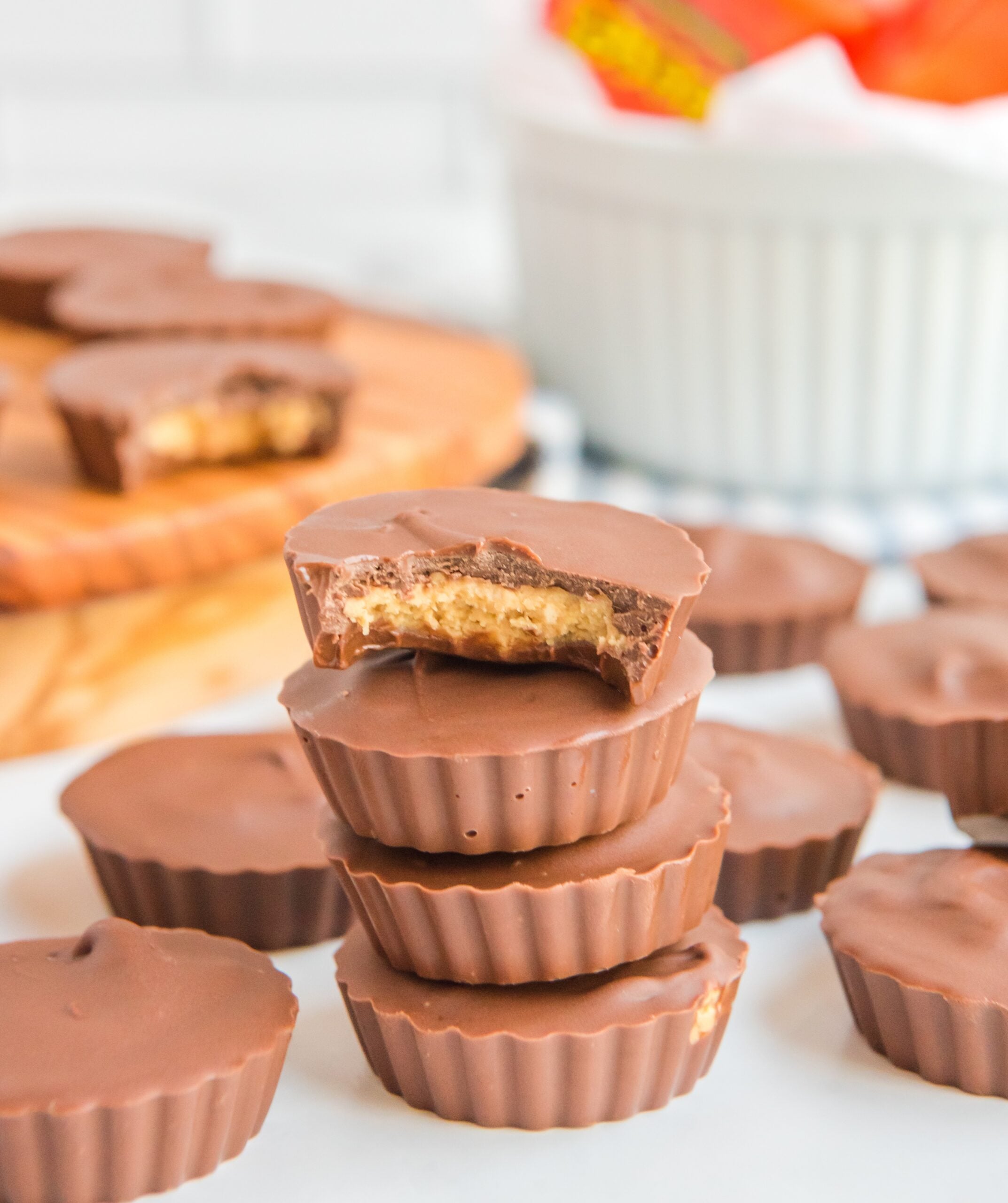 stack of homemade Peanut Butter Cups with a bite missing from the top one showing the inside