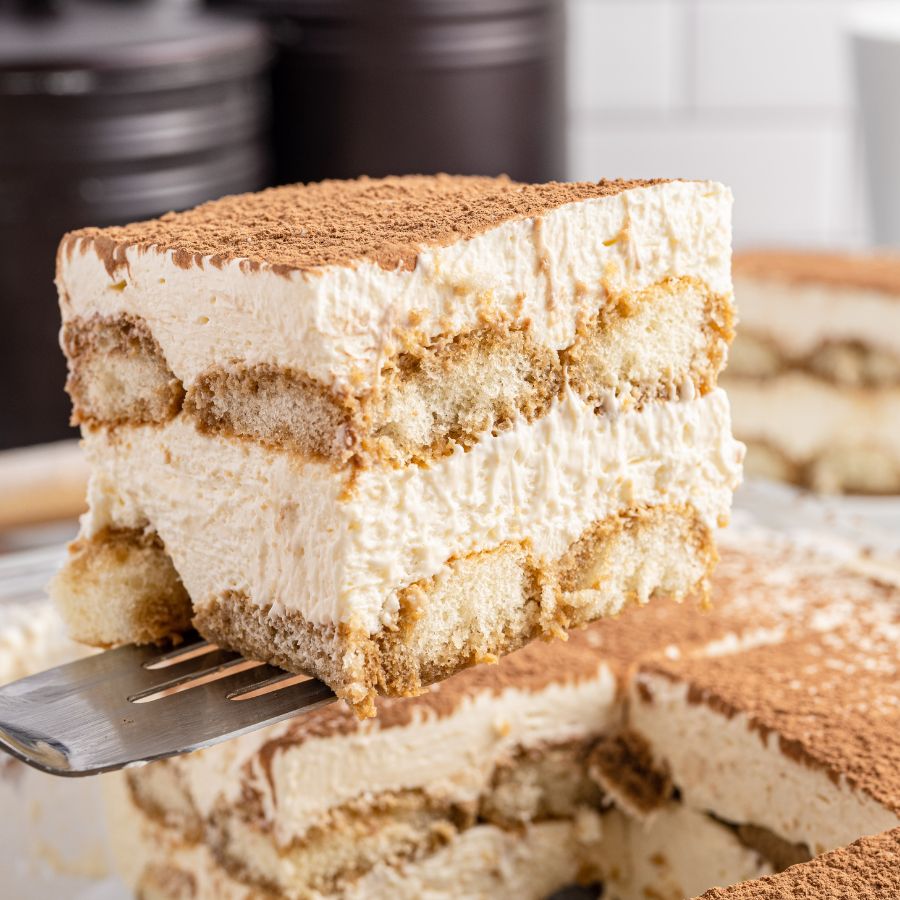 slice of tiramisu being lifted out of pan with a spatula