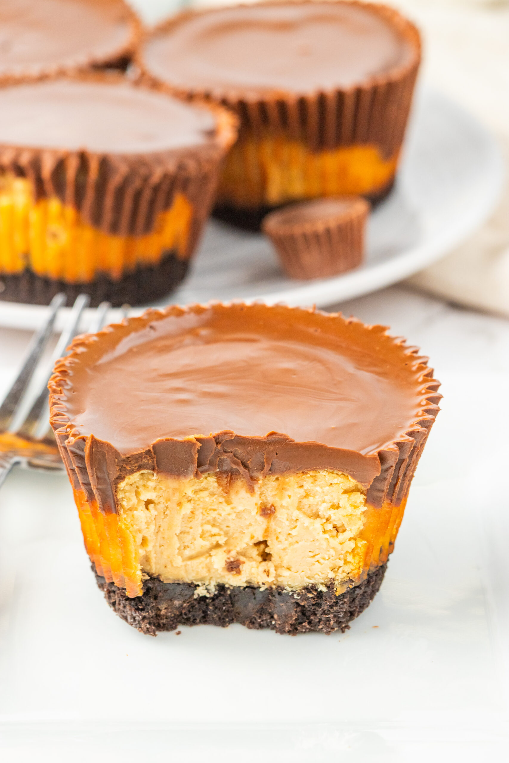 Peanut Butter Cheesecake Bite cut in half and sitting on table