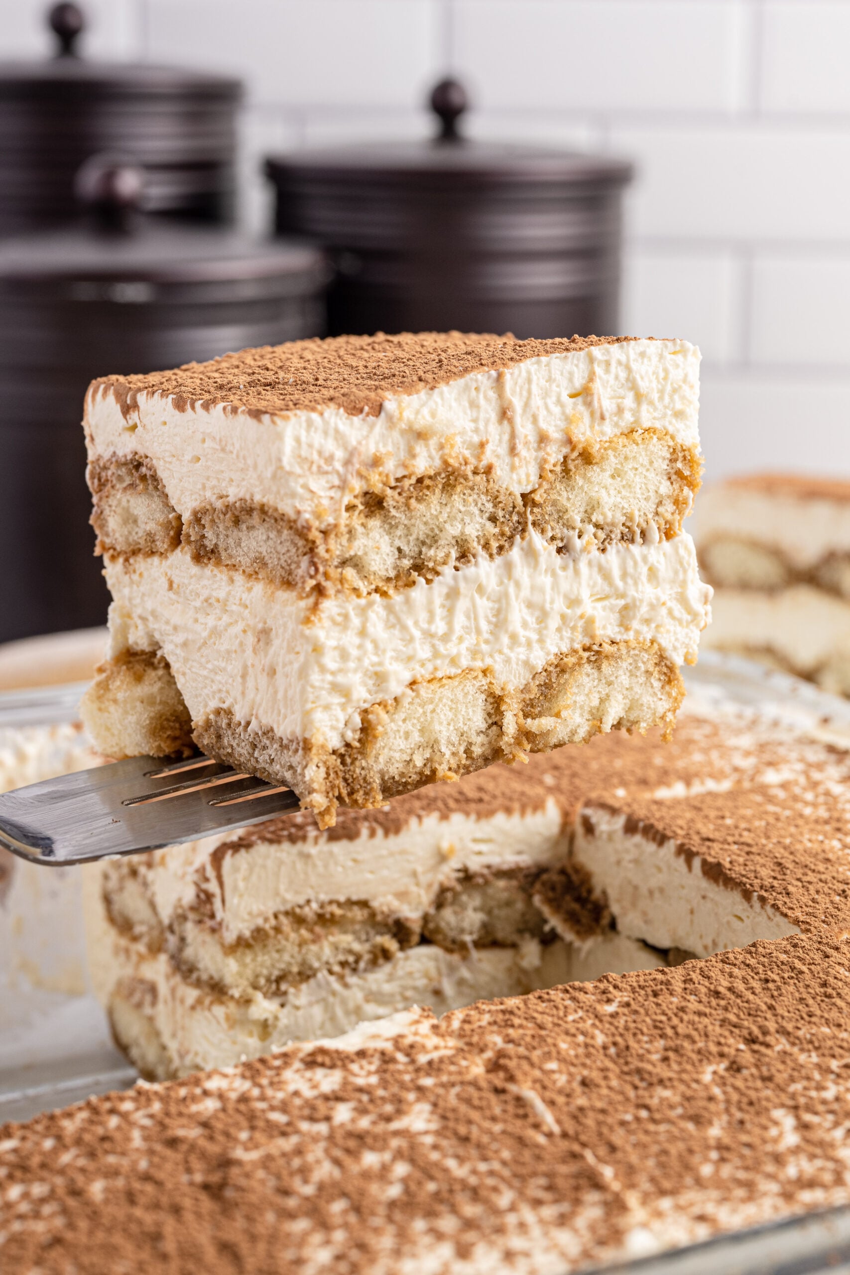 slice of tiramisu being lifted out of pan with a spatula