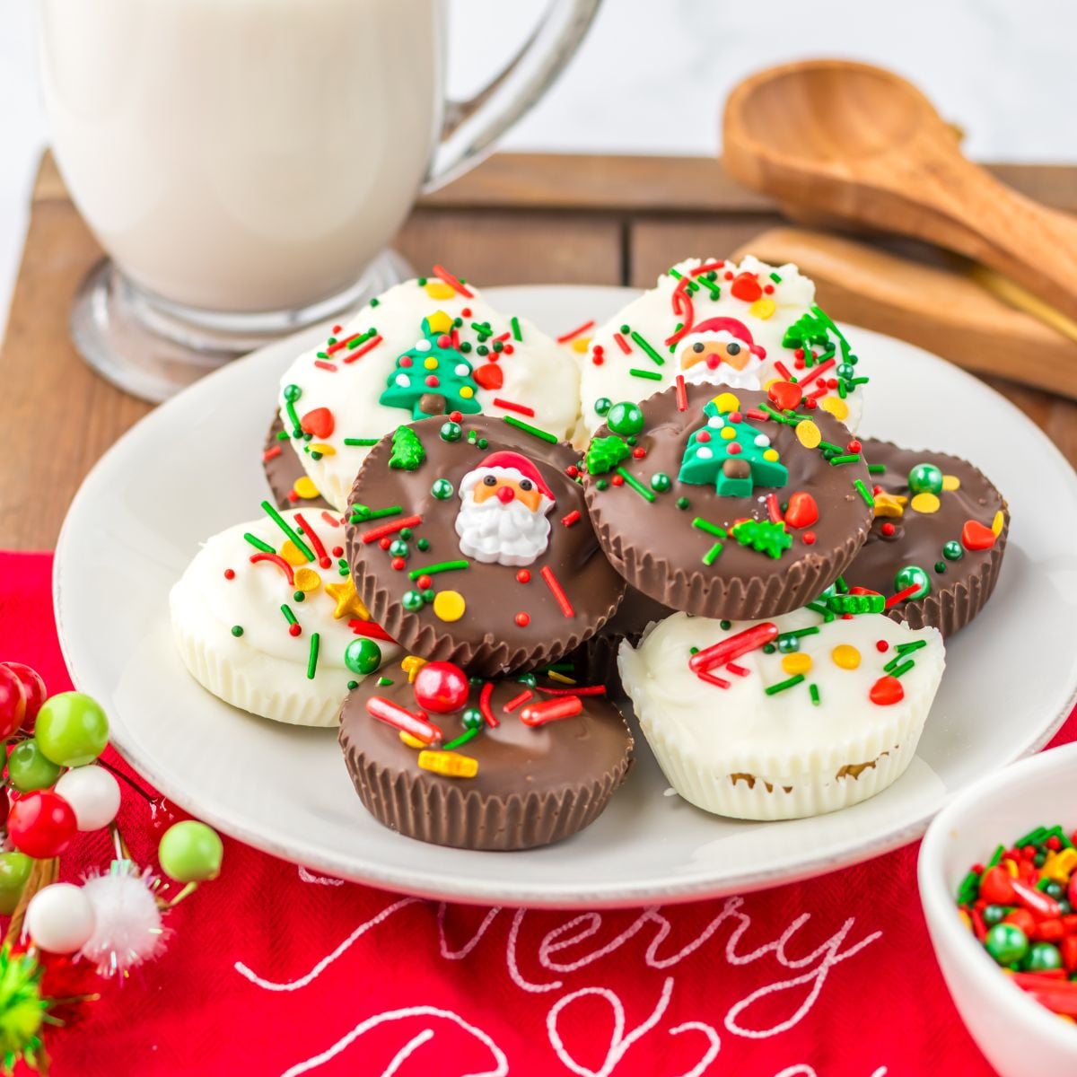 Christmas Peanut Butter Cups on a plate with a glass of milk in the background