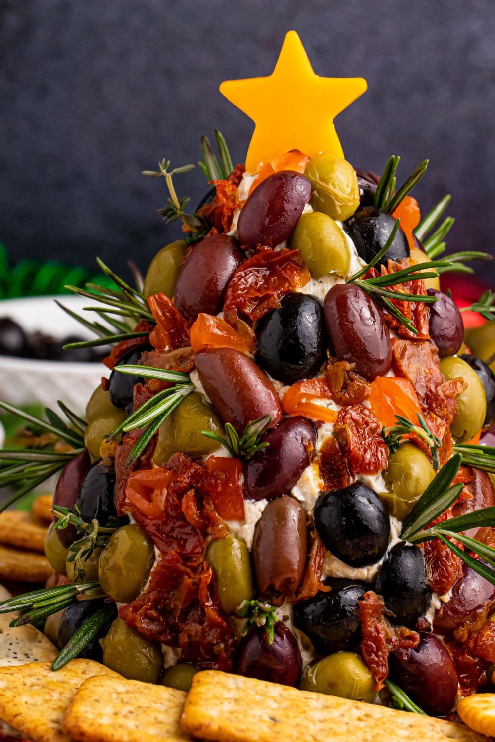 cheese dip shaped liek a tree with crackers around it on table