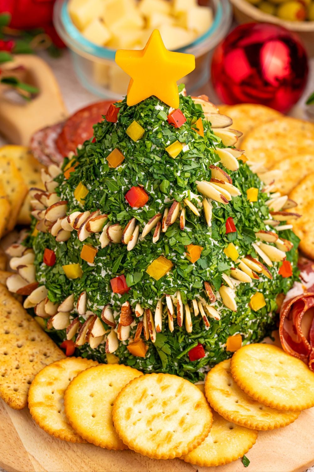 side view of cheeseball with crackers and such around the board
