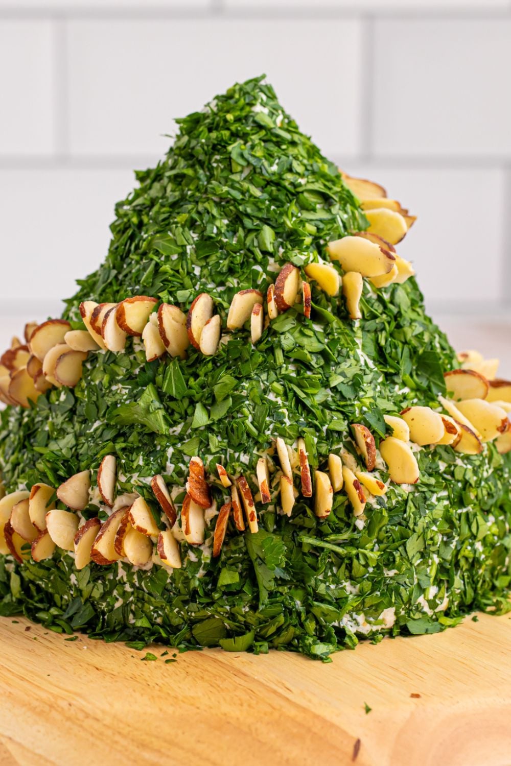side view of cheeseball being decorated