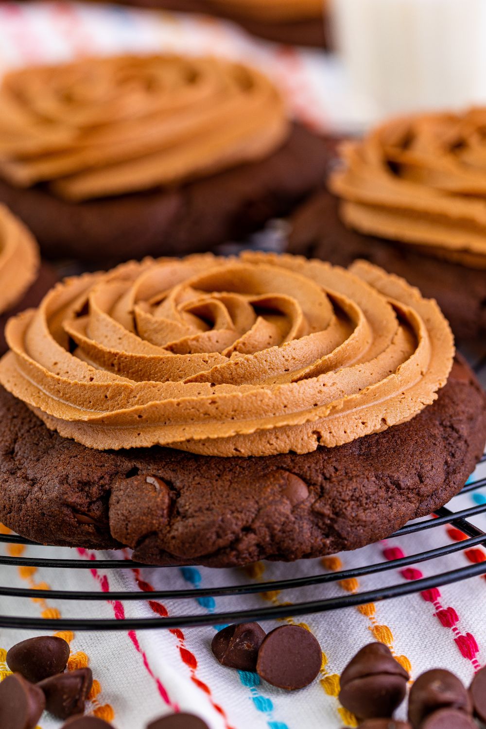 close up of Chocolate Cake Cookies on a metal tray with a towel and chocolate chps under the tray 