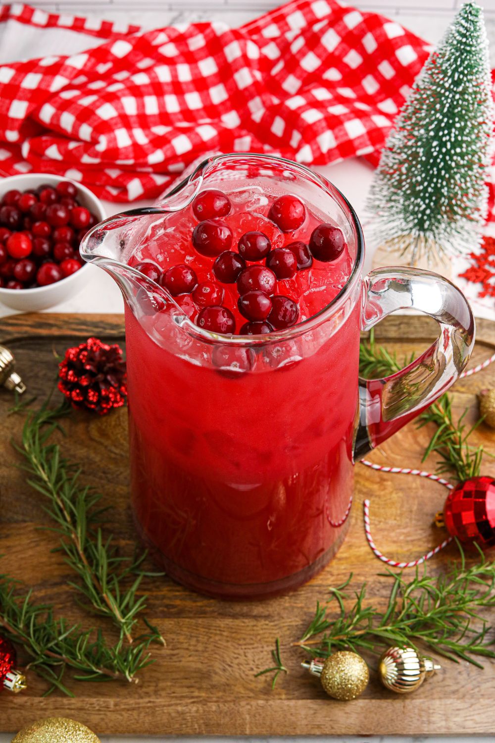 Mistletoe Punch in a pitcher on table with Christmas decora around it