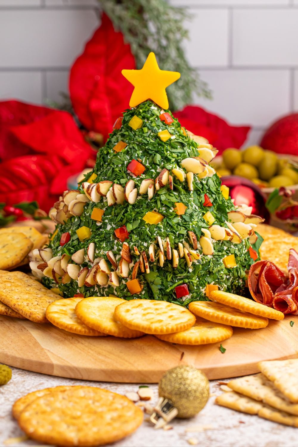 Christmas Tree Cheeseball on table with ingredients around it