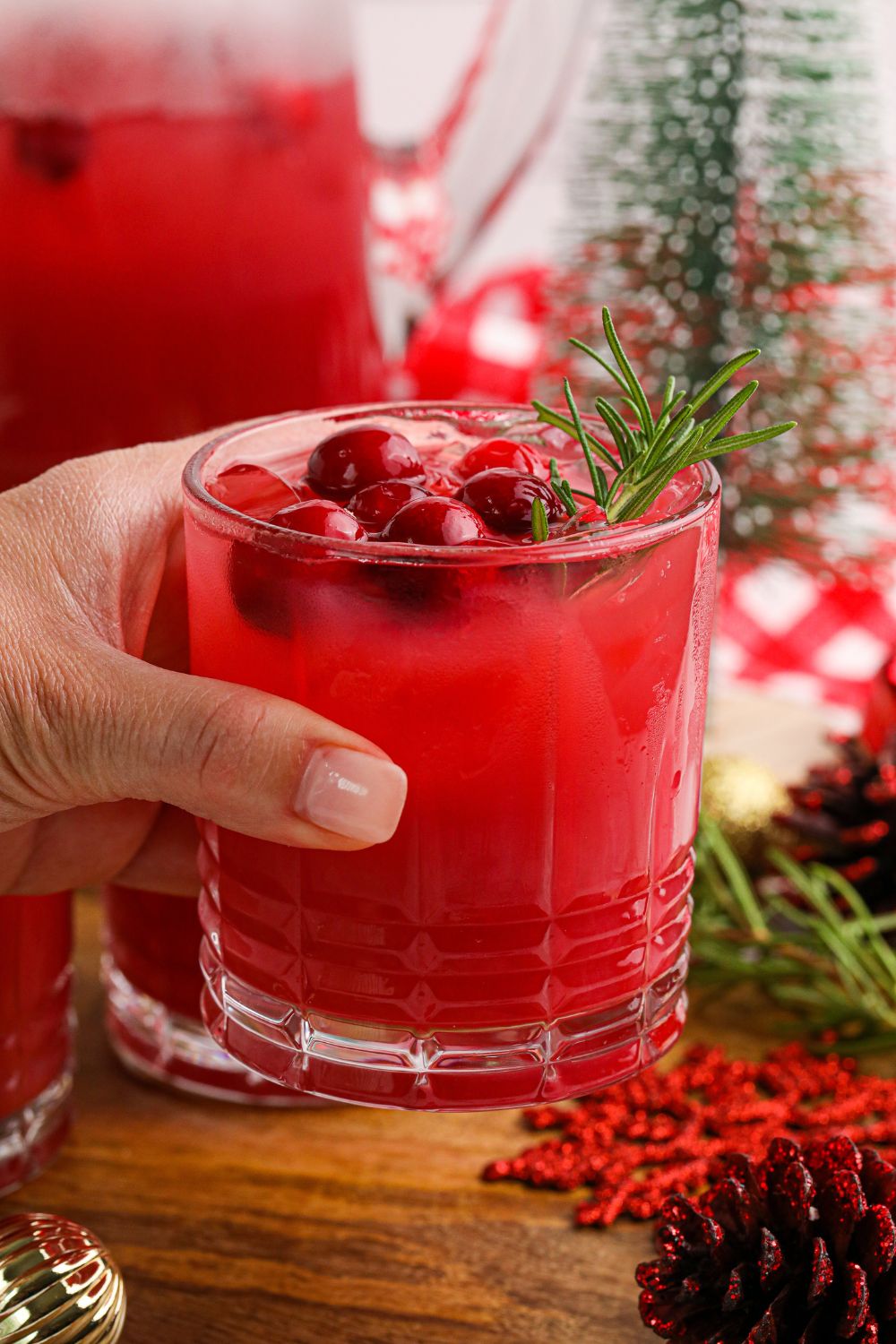 christmas cocktail punch in hand in a glass