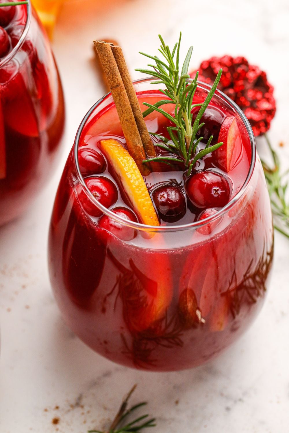 glass of wine with fruit in it on a marble table