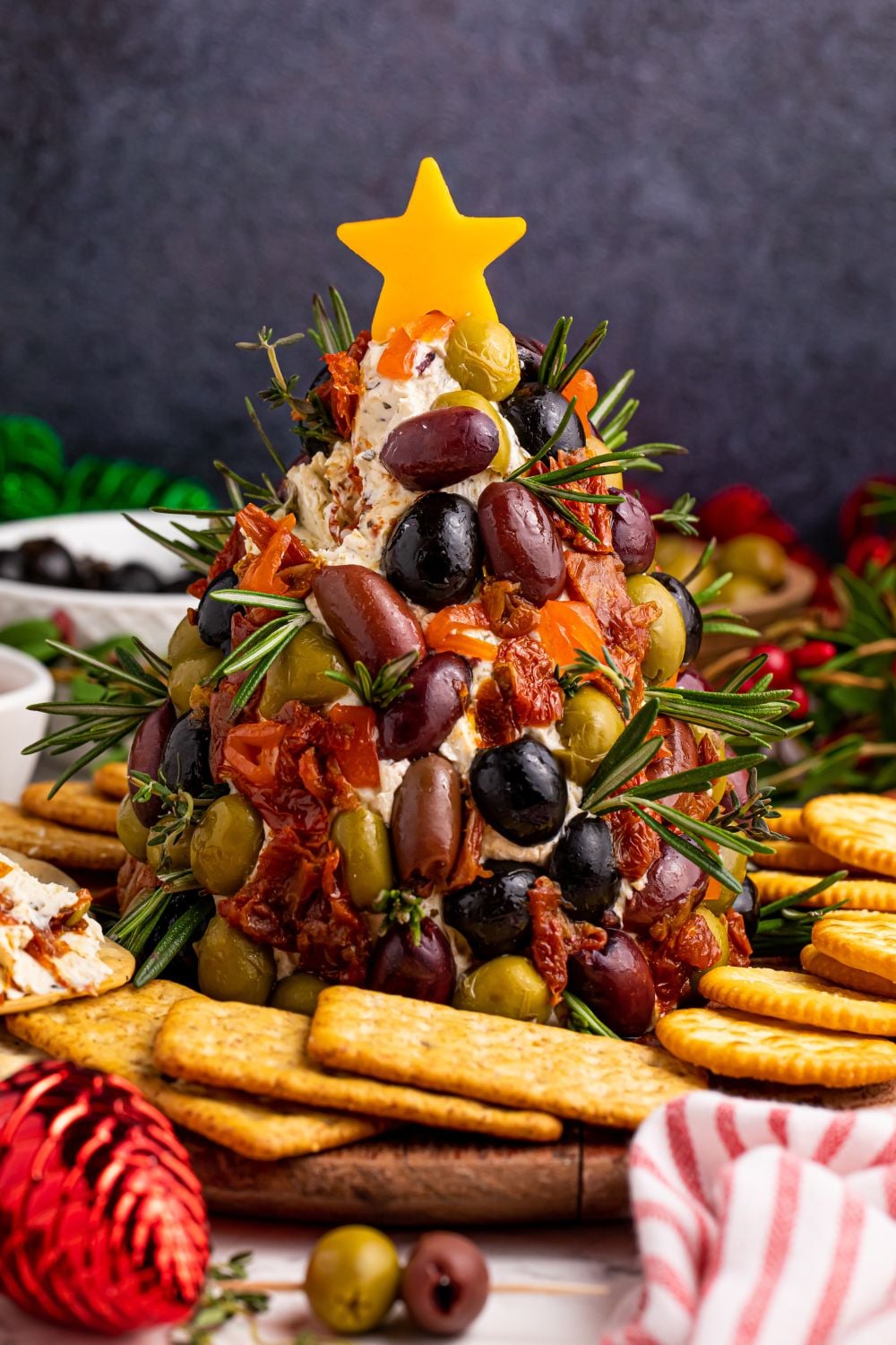 cheseball on table with a star on top and crackers around it on tale