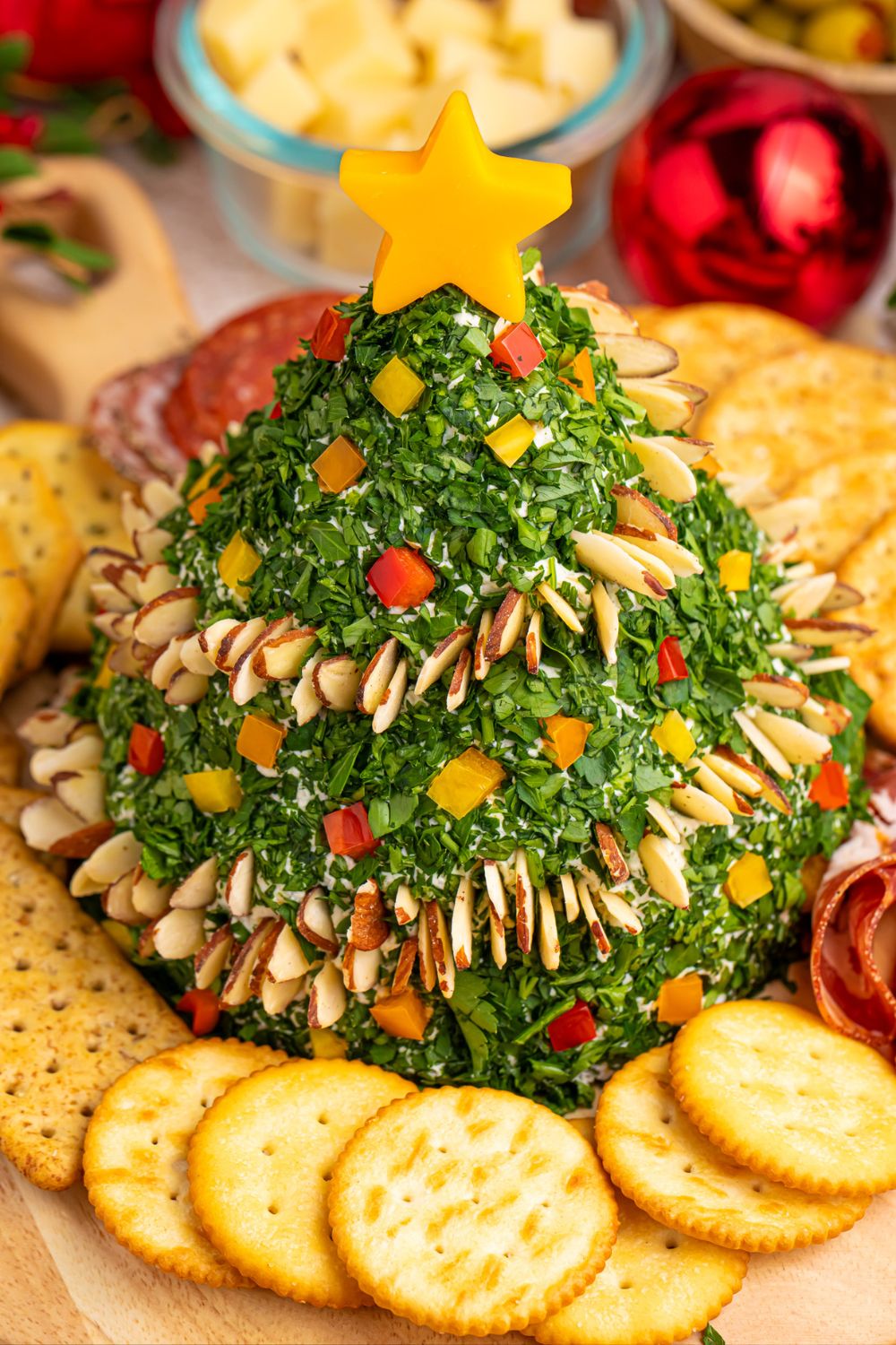 christmas tree dip on platter with crackers around it