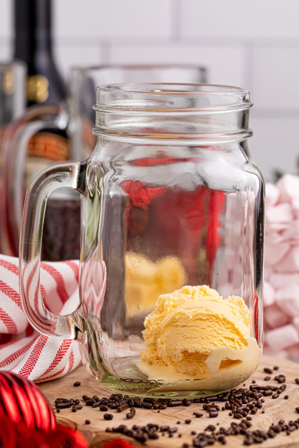 scoop of vanilla ice cream in a glass mason jar sitting on a table
