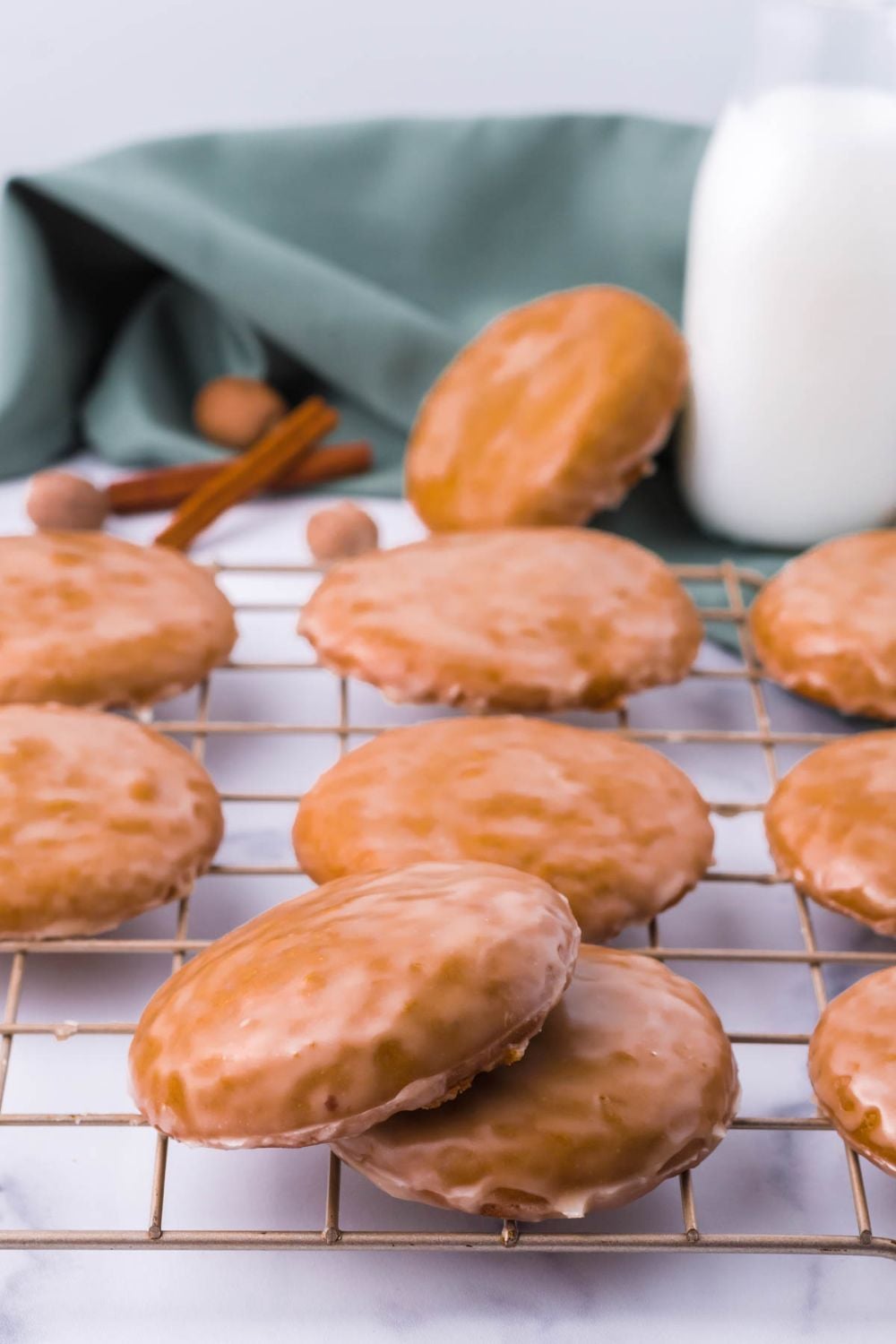 German cookies on a cooling rack with a bottle of milk behind it on the table
