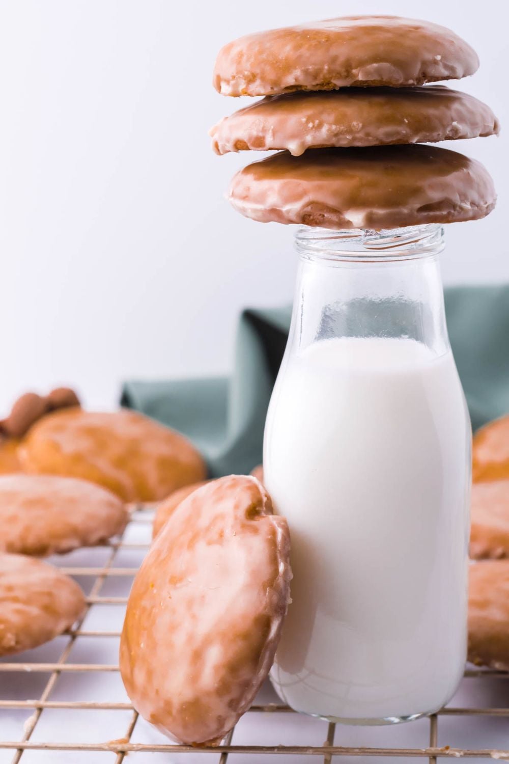 glass milk bottle with cookies on top and on the side