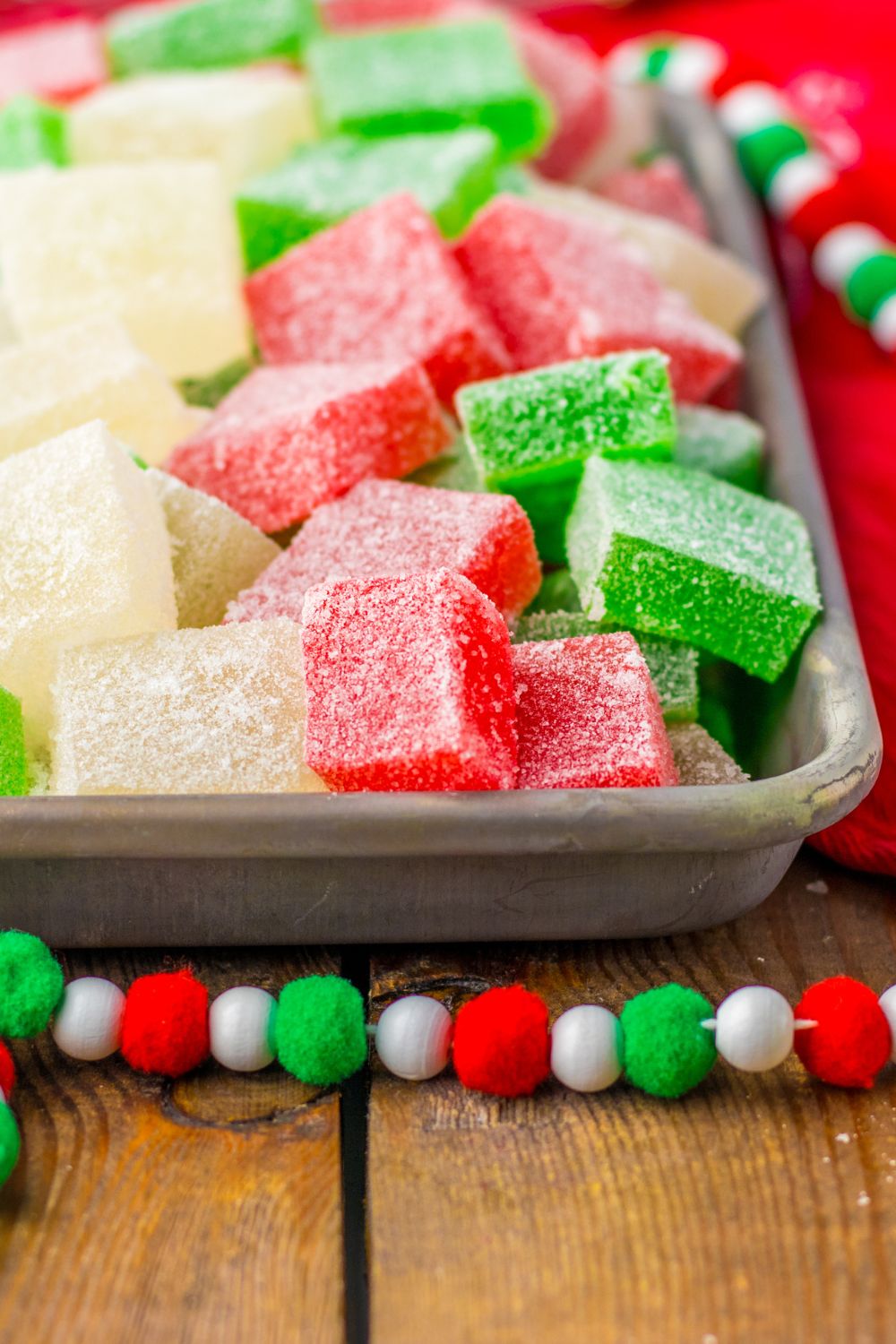 gumdrops in a pan with garland around the pan