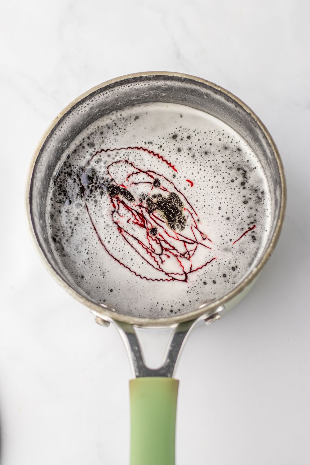 gelatin in pan with food coloring swirled on top 