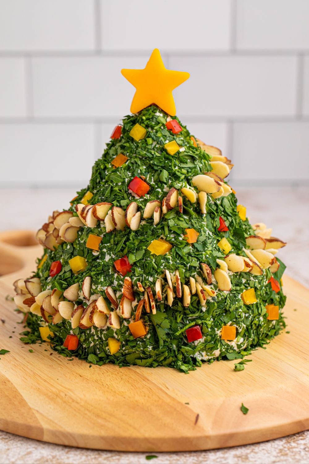 Christmas Tree Cheeseball on a wooden cutting board