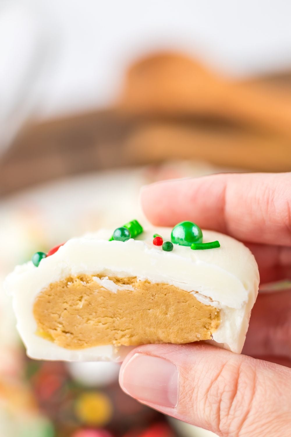peanut butter cup with white chocolate cut in half being held in hands