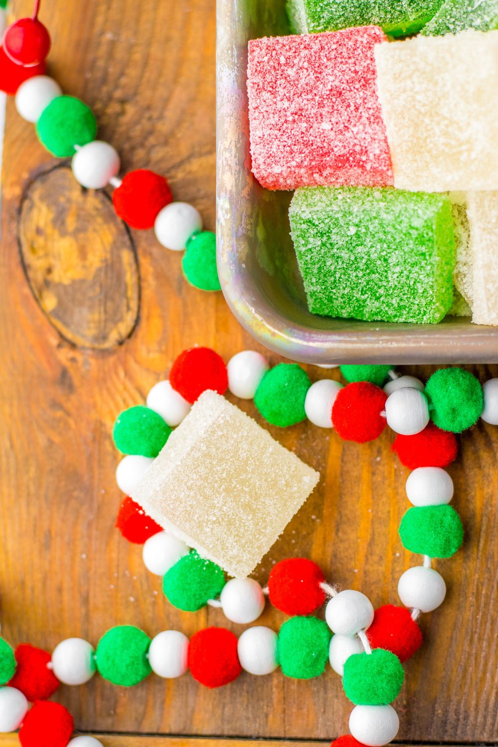 easy homemade gumdrops on table with christmas garland around it 
