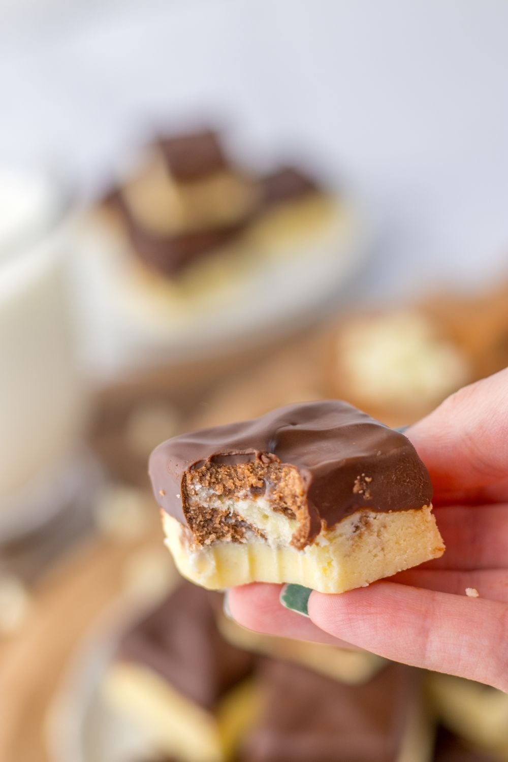 holding a piece of fudge with bite taken out