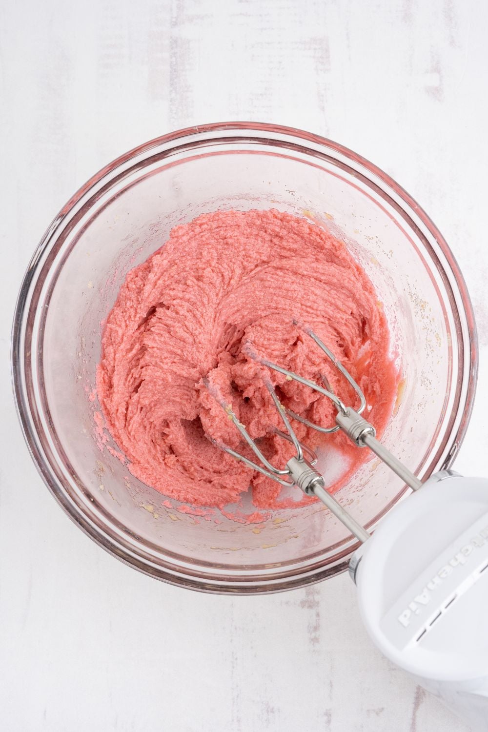 The prochess of mixing up the Cherry Chocolate Chip Cookie dough in a glass bowl 