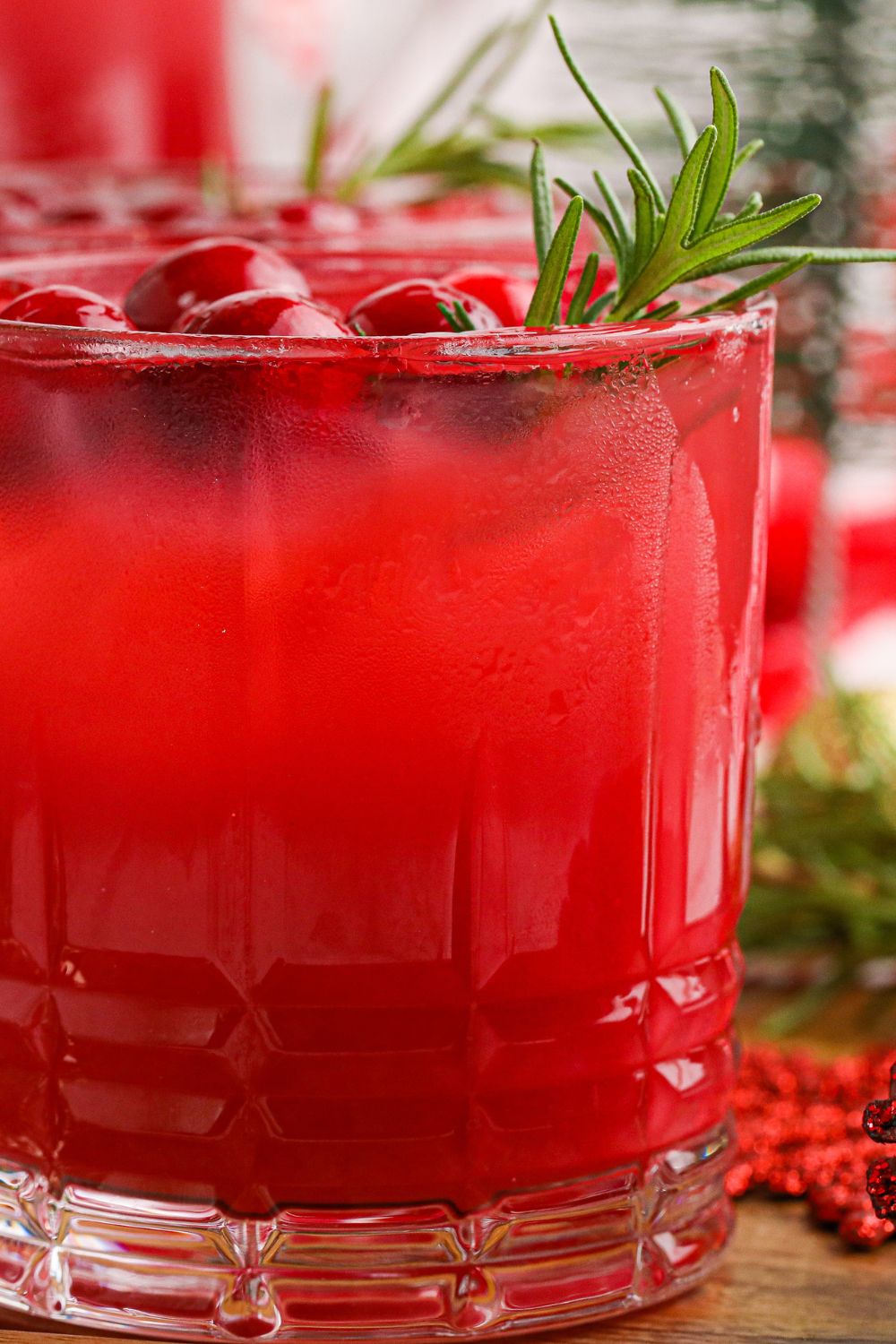 side view of cranberry orange punch in a glass
