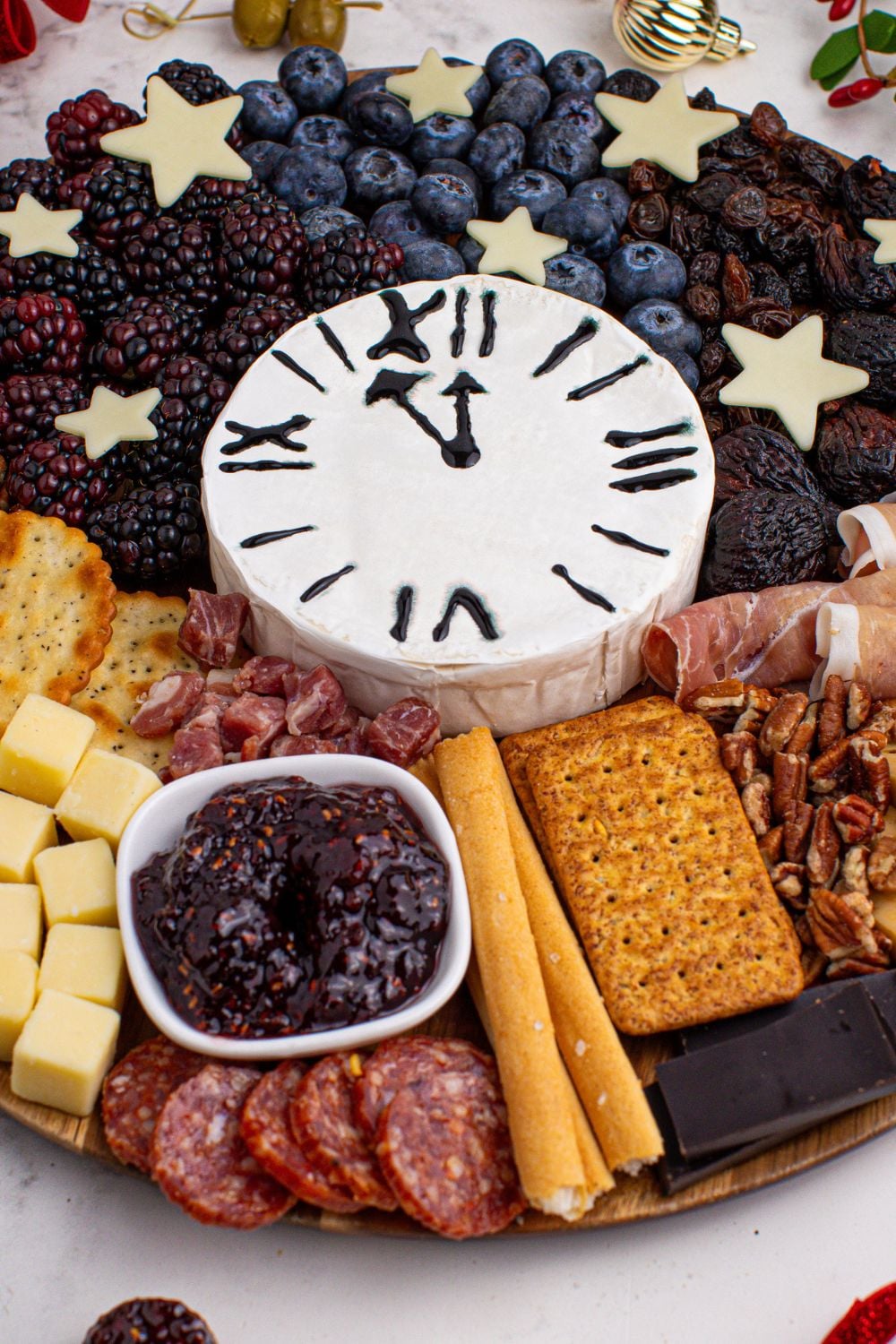 New Year's Eve Charcuterie Board on table with a close up view to see a variety of foods on the table 