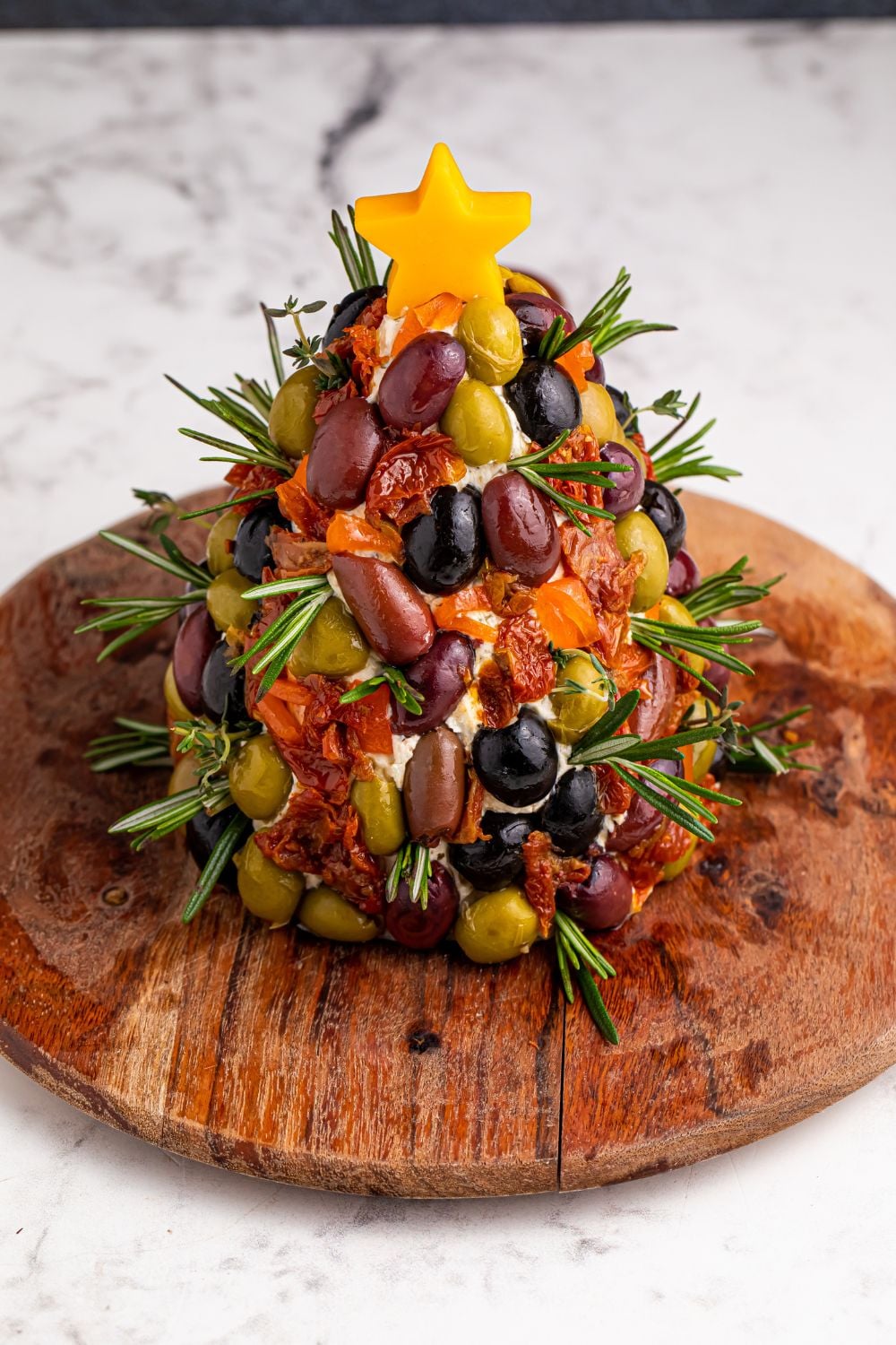 overhead look of cheeseball on a round cutting board on table