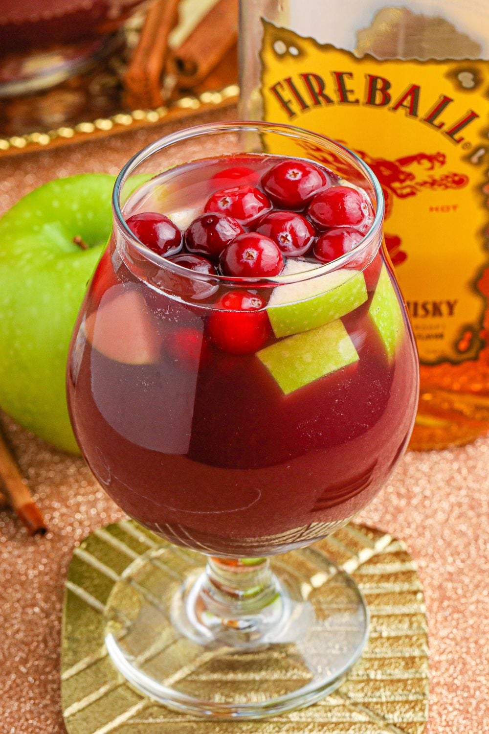 sangria with fresh fruit on table with fireball whiskey in background