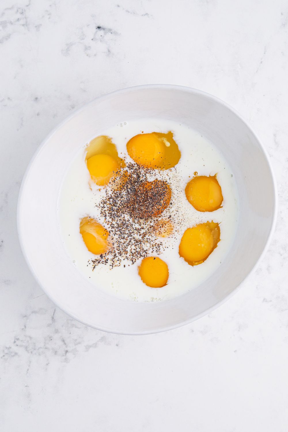 mixing up eggs with milk and seasonings for Breakfast Sliders