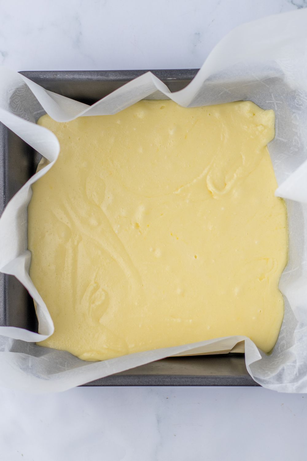 vanilla fudge in a pan with parchment paper
