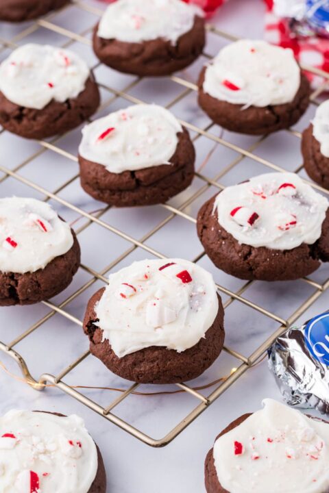 cream cheese topped peppermint chocolate cookies on a cooling rack 