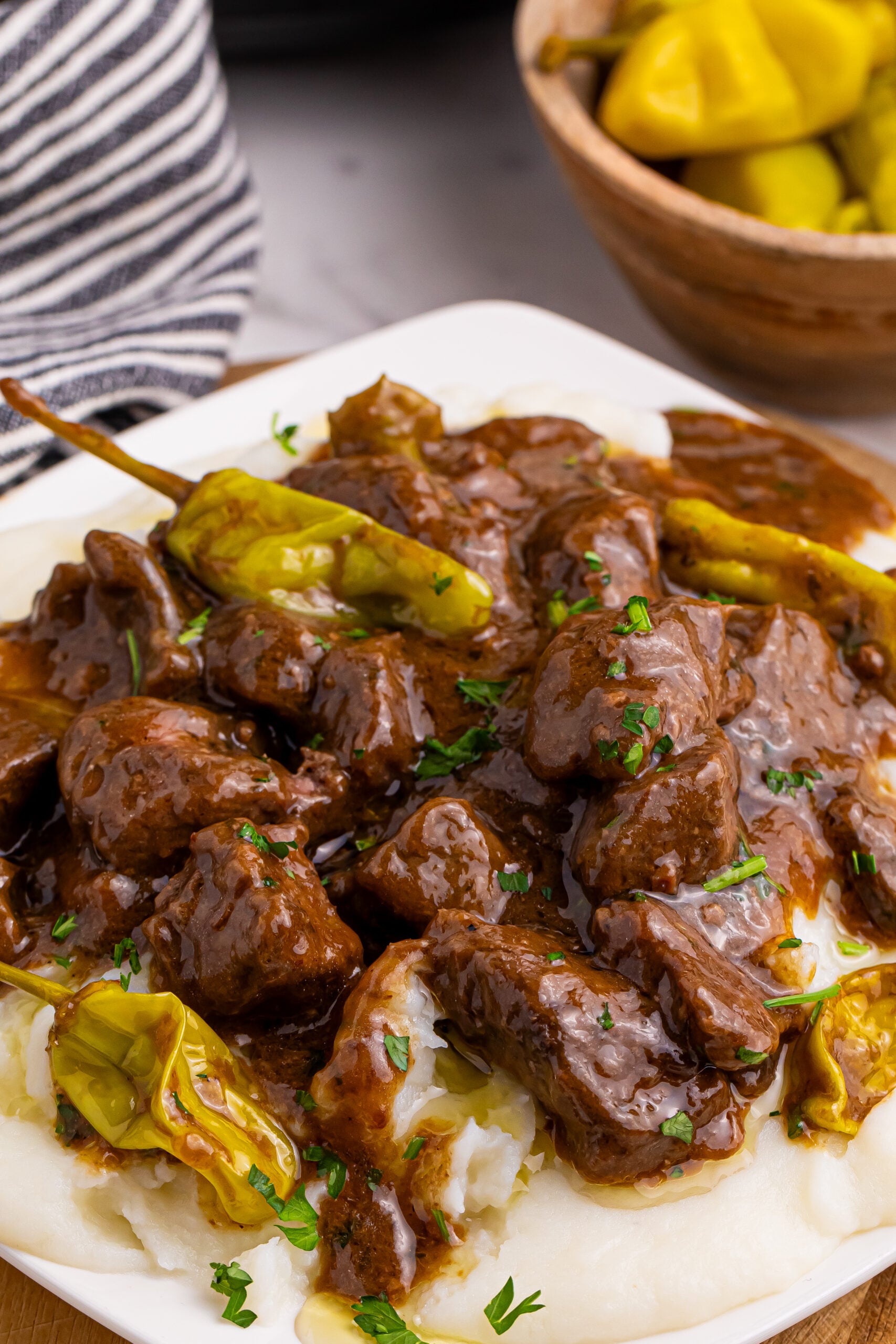 Crockpot Mississippi Steak Bites on a plate with mashed potatoes.