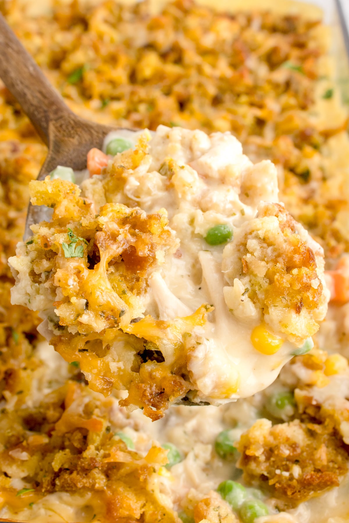 Chicken Stuffing Casserole with a scoop being lifted out of the casserole dish