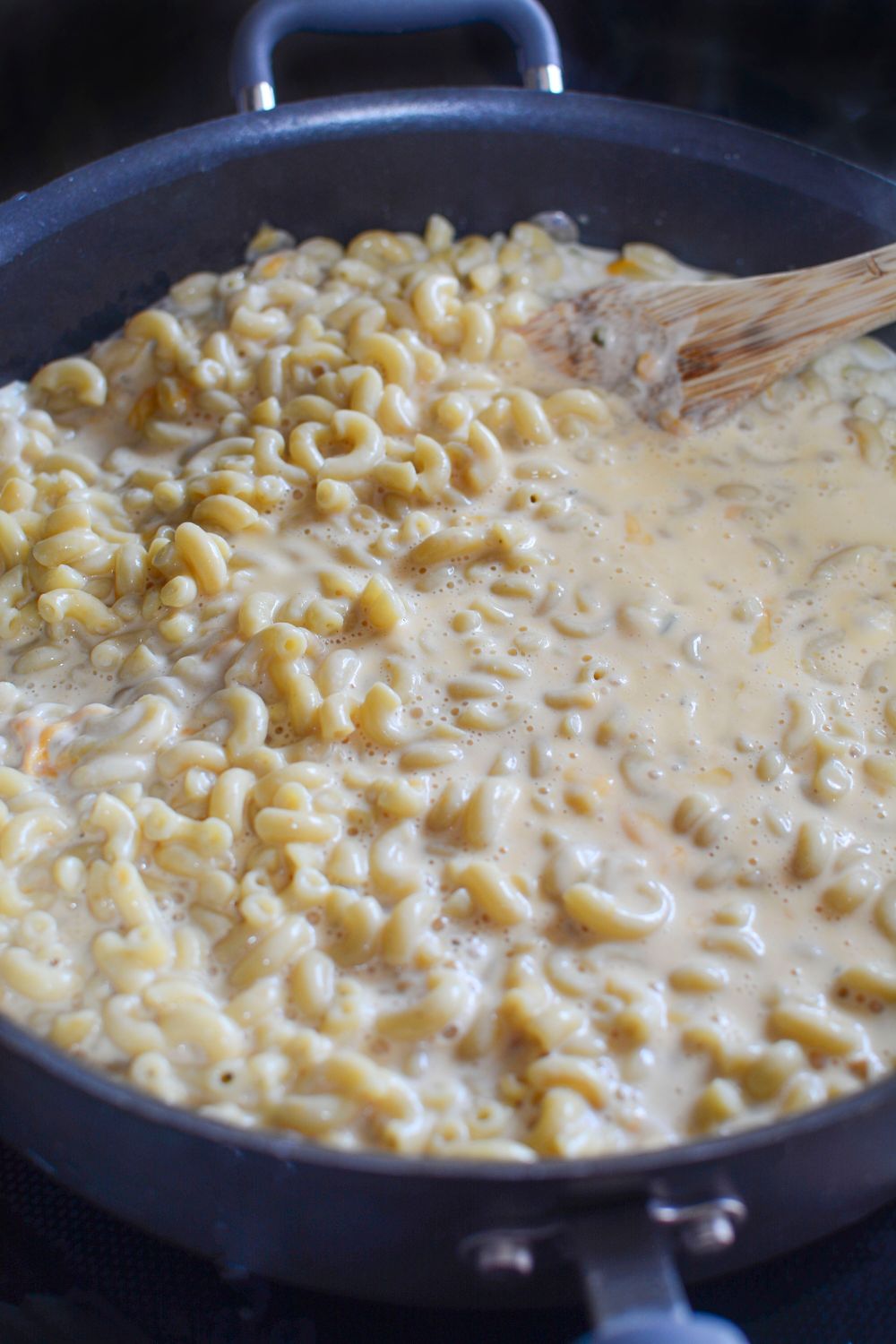 Big Mac Macaroni And Cheese mixture in a pan, it is the macaroni and cheese in a pan on stovetop