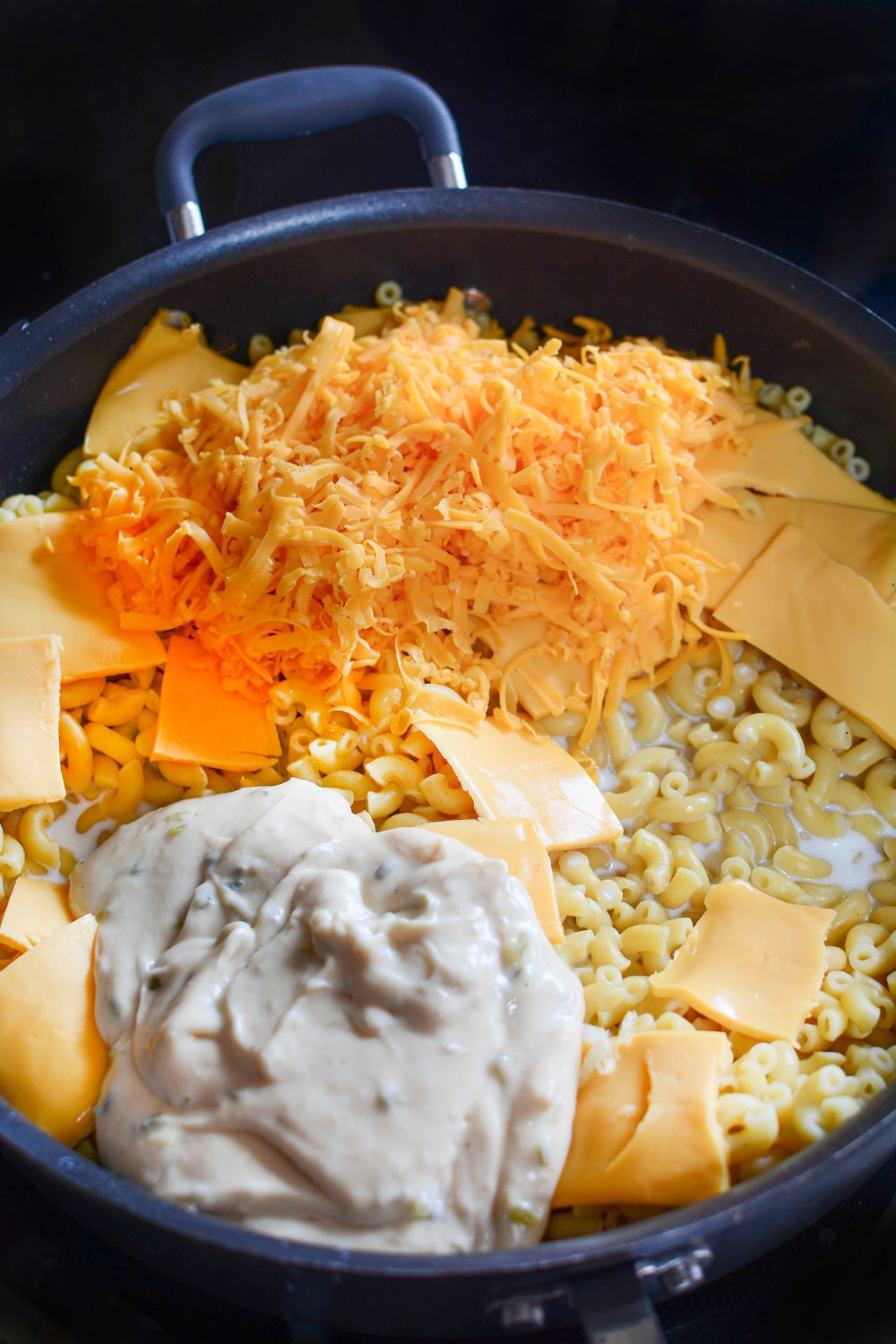all the cheese in a skillet on the stove for making Big Mac Macaroni And Cheese