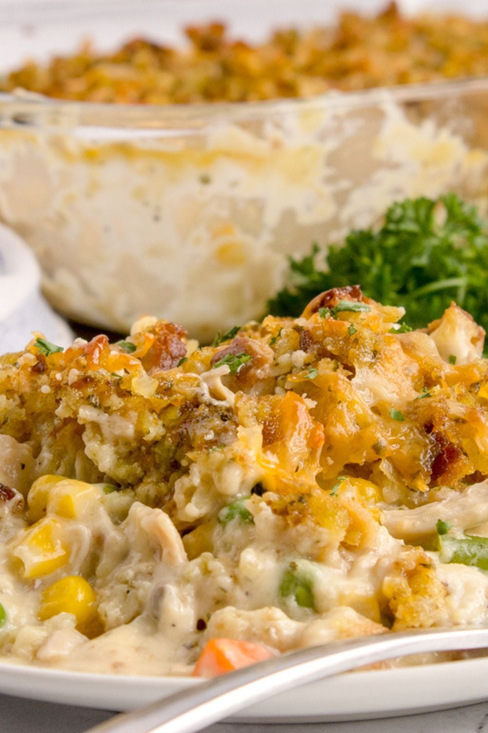 Chicken Stuffing Casserole on plate with a close up of pan behind it on table