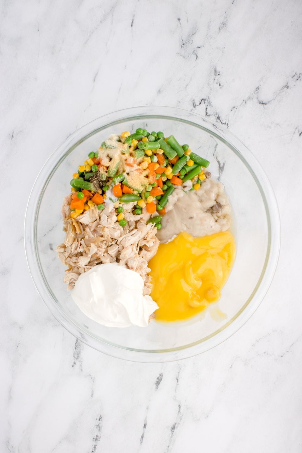 Chicken Stuffing Casserole ingredients in a glass bowl on table