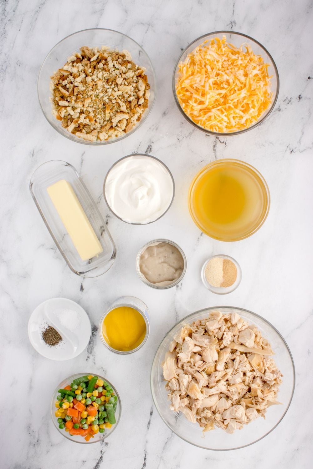 Chicken Stuffing Casserole ingredients in glass bowls sitting on table to showcase what you need for cassserole