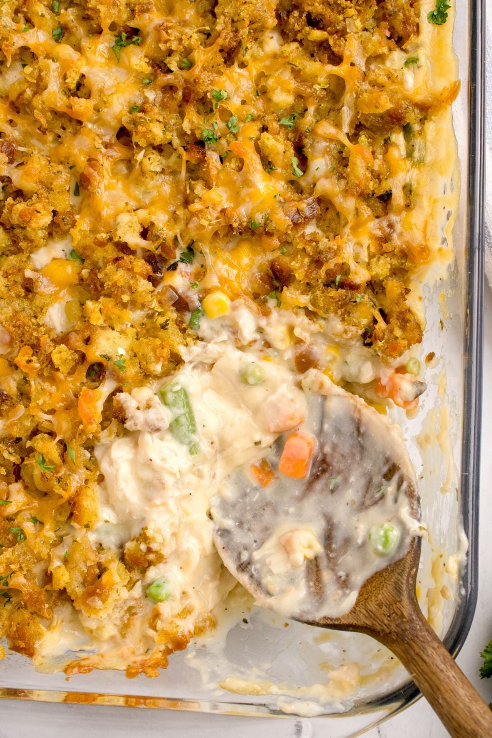 Chicken Stuffing Casserole in pan with a few scoops missing from pan showing the center of the casserole